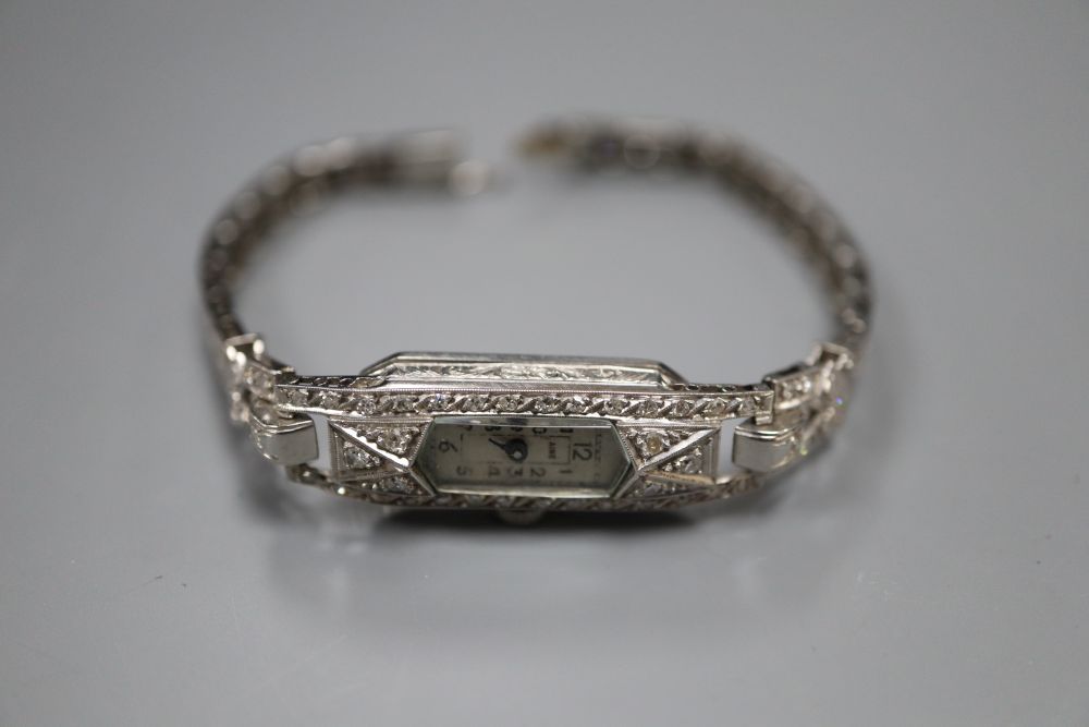 A ladys mid 20th century white metal (tests as platinum) and diamond set cocktail wrist watch, on diamond set bracelet, 16.5cm,